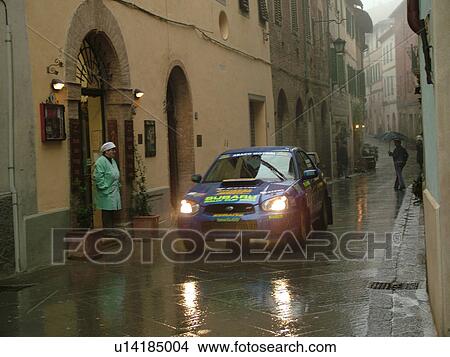 rally car, Italy, Tuscany, Montalcino, Toscana, Europe, Trofeo Rally Coppa Liburna car race through the narrow streets of the medieval town of Montalcino on a rainy day. View Large Photo Image Picture - rally car, Italy, Tuscany, Montalcino, Toscana, Europe, Trofeo Rally Coppa Liburna car race through the narrow streets of the medieval town of Montalcino on a rainy day.. Fotosearch
