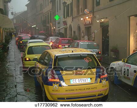 rally car, Italy, Tuscany, Montalcino, Toscana, Italy, Europe, The starting line up of the Trofeo Rally Coppa Liburna car race through the narrow streets of the medieval town of Montalcino on a rainy day. View Large Photo Image Stock Image - rally car, Italy, Tuscany, Montalcino, Toscana, Italy, Europe, The starting line up of the Trofeo Rally Coppa Liburna car race through the narrow streets of the medieval town of Montalcino on a rainy day.. Fotosearch
