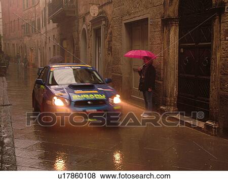rally car, Italy, Tuscany, Montalcino, Toscana, Europe, Trofeo Rally Coppa Liburna car race through the narrow streets of the medieval town of Montalcino on a rainy day. View Large Photo Image Stock Photo - rally car, Italy, Tuscany, Montalcino, Toscana, Europe, Trofeo Rally Coppa Liburna car race through the narrow streets of the medieval town of Montalcino on a rainy day.. Fotosearch