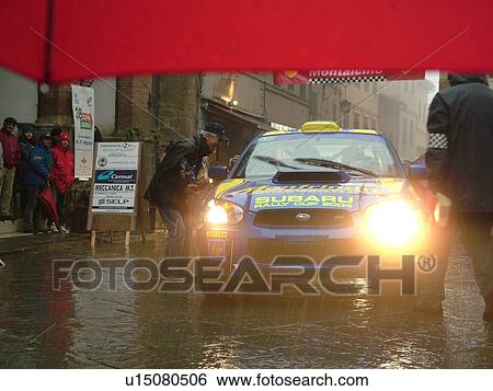 rally car, Italy, Tuscany, Montalcino, Toscana, Europe, The starting line of the Trofeo Rally Coppa Liburna car race through the narrow streets of the medieval town of Montalcino on a rainy day. View Large Photo Image Stock Photograph - rally car, Italy, Tuscany, Montalcino, Toscana, Europe, The starting line of the Trofeo Rally Coppa Liburna car race through the narrow streets of the medieval town of Montalcino on a rainy day.. Fotosearch