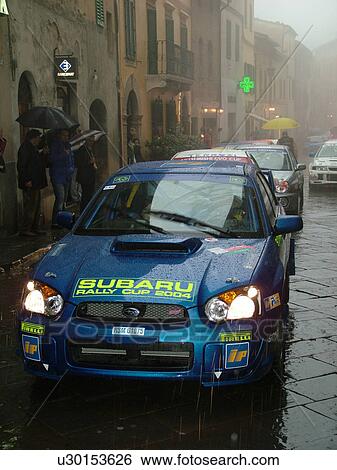 rally car, Montalcino, Tuscany, Toscana, Italy, Europe, The starting line up of the Trofeo Rally Coppa Liburna car race through the narrow streets of the medieval town of Montalcino on a rainy day. View Large Photo Image Stock Photograph - rally car, Montalcino, Tuscany, Toscana, Italy, Europe, The starting line up of the Trofeo Rally Coppa Liburna car race through the narrow streets of the medieval town of Montalcino on a rainy day.. Fotosearch