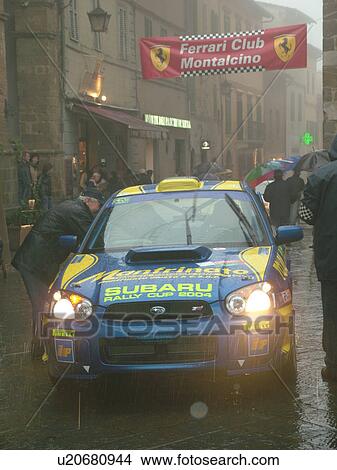 Picture -  rally car, Toscana, Tuscany, Italy, Montalcino, Europe, The starting line of the Trofeo Rally Coppa Liburna car race through the narrow streets of the medieval town of Montalcino on a rainy day.. Fotosearch