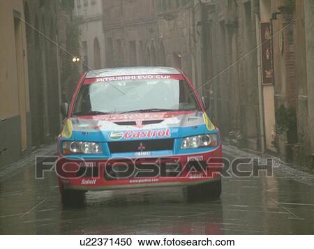 rally car, Toscana, Tuscany, Italy, Montalcino, Europe, Trofeo Rally Coppa Liburna car race through the narrow streets of the medieval town of Montalcino on a rainy day. View Large Photo Image Stock Image - rally car, Toscana, Tuscany, Italy, Montalcino, Europe, Trofeo Rally Coppa Liburna car race through the narrow streets of the medieval town of Montalcino on a rainy day.. Fotosearch