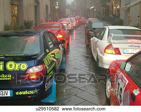 rally car, Toscana, Tuscany, Italy, Montalcino, Europe, The starting line up of the Trofeo Rally Coppa Liburna car race through the narrow streets of the medieval town of Montalcino on a rainy day. View Large Photo Image Stock Image - rally car, Toscana, Tuscany, Italy, Montalcino, Europe, The starting line up of the Trofeo Rally Coppa Liburna car race through the narrow streets of the medieval town of Montalcino on a rainy day.. Fotosearch
