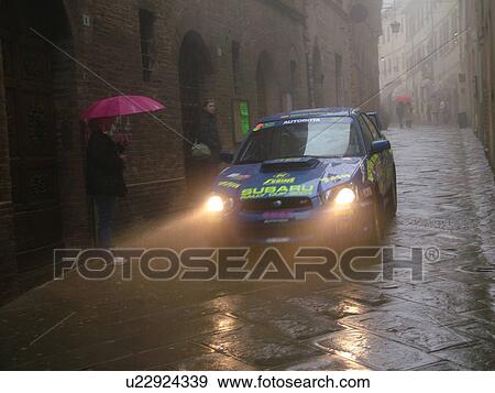 rally car, Tuscany, Italy, Montalcino, Toscana, Europe, Trofeo Rally Coppa Liburna car race through the narrow streets of the medieval town of Montalcino on a rainy day. View Large Photo Image Stock Photo - rally car, Tuscany, Italy, Montalcino, Toscana, Europe, Trofeo Rally Coppa Liburna car race through the narrow streets of the medieval town of Montalcino on a rainy day.. Fotosearch