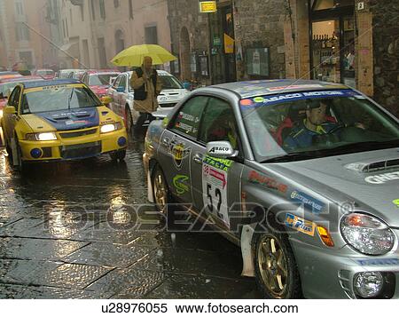 rally car, Tuscany, Montalcino, Toscana, Italy, Europe, The starting line up of the Trofeo Rally Coppa Liburna car race through the narrow streets of the medieval town of Montalcino on a rainy day. View Large Photo Image Stock Photography - rally car, Tuscany, Montalcino, Toscana, Italy, Europe, The starting line up of the Trofeo Rally Coppa Liburna car race through the narrow streets of the medieval town of Montalcino on a rainy day.. Fotosearch