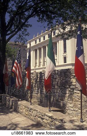 Stock Image -  San Antonio, TX, Texas, Flags on The Alamo grounds. Fotosearch