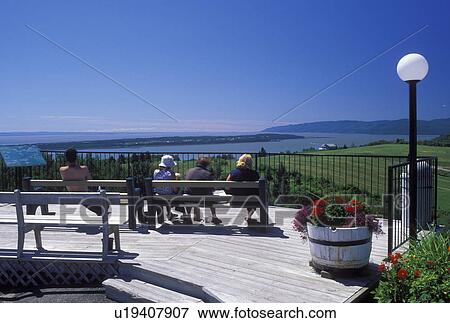 St. Lawrence River, Canada, Quebec, Les Eboulements, People sitting at an overlook in Les Eboulements viewing the scenic countryside along the St. Lawrence River (Fleuve Saint-Laurent) View Large Photo Image Stock Photo - St. Lawrence River, Canada, Quebec, Les Eboulements, People sitting at an overlook in Les Eboulements viewing the scenic countryside along the St. Lawrence River (Fleuve Saint-Laurent). Fotosearch