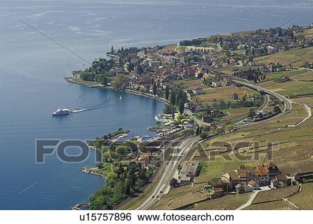 Stock Photograph -  Switzerland, Vaud, Lavaux, Cully, Lake Geneva, Europe, Scenic view of an excursion steamer boat cruising along the lakeshore of Lac Leman from the steep slopes of the vineyards of Lavaux in the Canton of Vaud. . Fotosearch