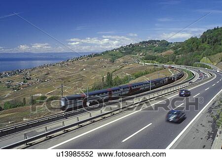 Switzerland, Vaud, Lavaux, Lake Geneva, Europe, Expressway and train line run through the scenic vineyards of Lavaux in the spring in the Canton of Vaud. View Large Photo Image Stock Image - Switzerland, Vaud, Lavaux, Lake Geneva, Europe, Expressway and train line run through the scenic vineyards of Lavaux in the spring in the Canton of Vaud. . Fotosearch