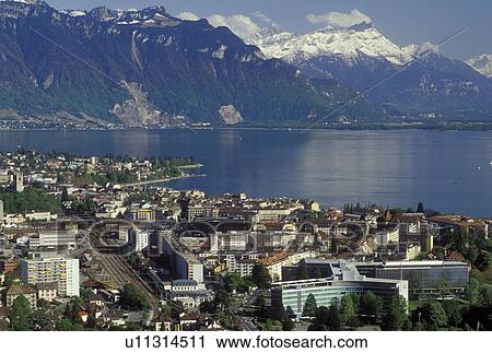 Switzerland, Vevey, Vaud, Lake Geneva, Lavaux, Alps, Europe, Scenic view of the city of Vevey and the Alps along the lakeshore of Lac Leman in the spring in the Canton of Vaud. View Large Photo Image Stock Image - Switzerland, Vevey, Vaud, Lake Geneva, Lavaux, Alps, Europe, Scenic view of the city of Vevey and the Alps along the lakeshore of Lac Leman in the spring in the Canton of Vaud.. Fotosearch
