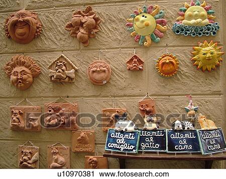 Stock Image -  terra cotta, Tuscany, Italy, Montalcino, Toscana, Europe, Terra cotta and ceramic crafts for sale outside a local store in the town of Montalcino.. Fotosearch