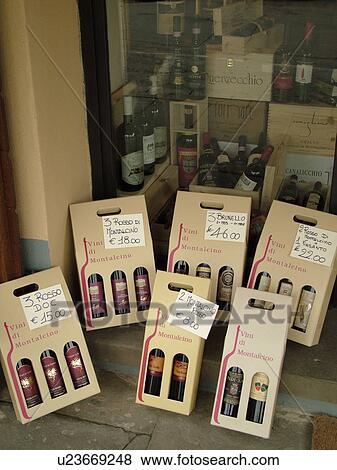 Stock Photo -  Tuscany, Italy, Montalcino, Toscana, Europe, Wine bottles for sale outside a wine shop in the town of Montalcino.. Fotosearch