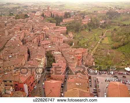 Stock Photo -  Tuscany, Italy, Siena, Toscana, Europe, Aerial view of the rooftops and city of Siena from The Torre del Mangia.. Fotosearch