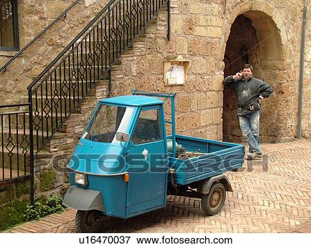Tuscany, Italy, Sovana, Toscana, Europe, Small blue three-wheeled pick-up truck parked in the medieval town of Sovana. View Large Photo Image Stock Photo - Tuscany, Italy, Sovana, Toscana, Europe, Small blue three-wheeled pick-up truck parked in the medieval town of Sovana.. Fotosearch