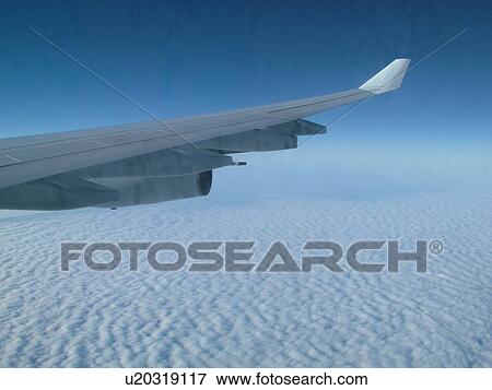 wing of airplane over clouds View Large Photo Image Stock Photo - wing of airplane over clouds . Fotosearch