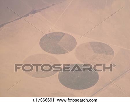 Aerial, airplane flying over farmland in the Rockies, circular fields, View Large Photo Image Stock Image - Aerial, airplane flying over farmland in the Rockies, circular fields, . Fotosearch