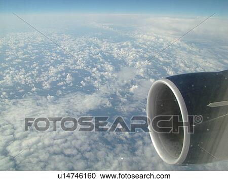 Stock Image -  Aerial, airplane flying over the Pacific Ocean, clouds, . Fotosearch