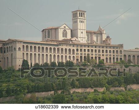 Stock Photo -  Assisi, Umbria, Italy, Europe, Basilica di San Francesco (Basilica of St. Francis of Assisi) and the Sacro Convento on the slopes of Monte Subasio in the medieval hill town of Assisi.. Fotosearch