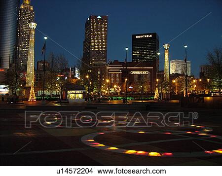 Picture -  Atlanta, GA, Georgia, Centennial Park, 1996 Summer Olympics, downtown skyline, evening, Christmas decorations, Fountain of Rings. Fotosearch