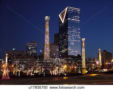 Stock Image -  Atlanta, GA, Georgia, Centennial Park, 1996 Summer Olympics, downtown skyline, evening, Christmas decorations. Fotosearch