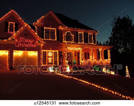 Stock Image -  Atlanta, GA, Georgia, house, Christmas decorations, evening. Fotosearch
