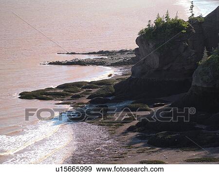 Stock Photo -  Canada, New Brunswick, Bay of Fundy, Hopewell Rocks Ocean Tidal Exploration Site, Big Cove, Hopewell Rocks, scenic coastline. Fotosearch