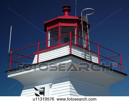 Stock Photograph -  Canada, New Brunswick, Bay of Fundy, Cape Enrage, Cape Enrage Lightstation ca. 1840, lighthouse. Fotosearch