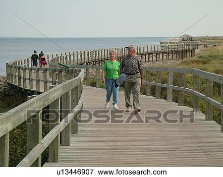Canada, New Brunswick, Bouctouche, Acadian Coastal Drive, La Dune de Bouctouche, Irving Eco-Centre, Boardwalk across the sand dunes along Bouctouche Bay. View Large Photo Image Stock Photo - Canada, New Brunswick, Bouctouche, Acadian Coastal Drive, La Dune de Bouctouche, Irving Eco-Centre, Boardwalk across the sand dunes along Bouctouche Bay.. Fotosearch