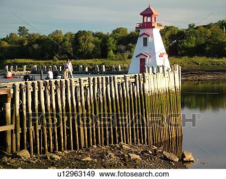 Stock Photo -  Canada, New Brunswick, St. Stephens, St. Croix River, Lighthouse along the Saint Croix River at low tide.. Fotosearch