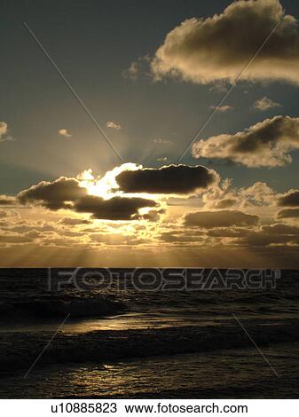 Stock Image -  Canada, Prince Edward Island, Gulf of Saint Lawrence, Cavendish Beach, Prince Edward Island National Park, Queens County, Sun rises over the Gulf of St. Lawrence. Fotosearch