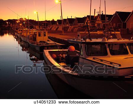Stock Image -  Canada, Prince Edward Island, Queens County, Gulf of Saint Lawrence, North Rustico, fishing village, harbor, fishing boats, marina, sunset. Fotosearch