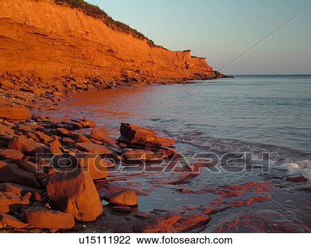 Stock Image -  Canada, Prince Edward Island, Queens County, Gulf of Saint Lawrence, Cavendish Beach, Prince Edward Island National Park, scenic coastline, early morning light. Fotosearch