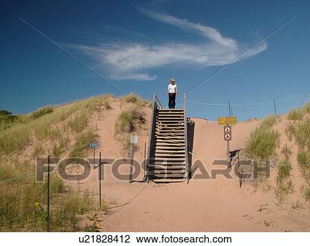 Canada, Prince Edward Island, Queens County, Gulf of Saint Lawrence, Cavendish Beach, Prince Edward Island National Park, sand dunes, beach, woman walking down steps View Large Photo Image Stock Image -  Canada, Prince Edward Island, Queens County, Gulf of Saint Lawrence, Cavendish Beach, Prince Edward Island National Park, sand dunes, beach, woman walking down steps. Fotosearch