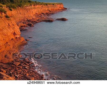 Stock Image -  Canada, Prince Edward Island, Queens County, Gulf of Saint Lawrence, Cavendish Beach, Prince Edward Island National Park, scenic coastline, early morning light. Fotosearch