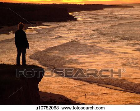 Canada, Prince Edward Island, Queens County, Gulf of Saint Lawrence, Cavendish Beach, Prince Edward Island National Park, scenic coastline, silhouette of woman at sunset View Large Photo Image Stock Photo - Canada, Prince Edward Island, Queens County, Gulf of Saint Lawrence, Cavendish Beach, Prince Edward Island National Park, scenic coastline, silhouette of woman at sunset. Fotosearch
