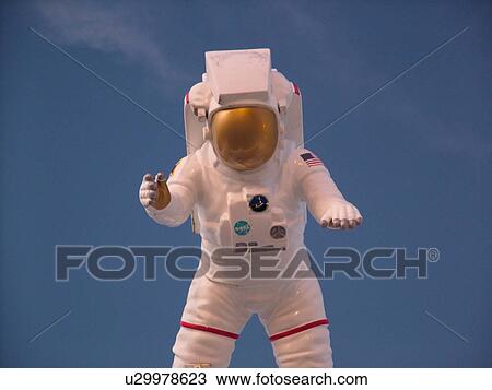 Stock Image -  Cape Canaveral, Titusville, Merritt Island, FL, Florida, John F. Kennedy Space Center Visitor Complex, Astronaut display against a dark blue sky . Fotosearch