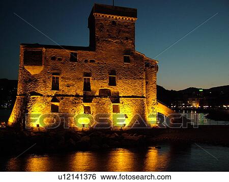 castle, Rapallo, Liguria, Italy, Riviera di Levante, Ligurian Riviera, Europe, The Castle at night on the Gulf of Tigullio (Gulfo di Tigullo) in the resort town of Rapallo along the Ligurian Sea on the Ligurian Riviera. View Large Photo Image Stock Photograph - castle, Rapallo, Liguria, Italy, Riviera di Levante, Ligurian Riviera, Europe, The Castle at night on the Gulf of Tigullio (Gulfo di Tigullo) in the resort town of Rapallo along the Ligurian Sea on the Ligurian Riviera.. Fotosearch