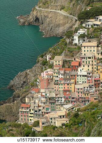 Cinque Terre, Liguria, Italy, Riomaggiore, Riviera di Levante, Ligurian Riviera, Europe, Scenic view of Riomaggiore, a Cinque Terre village, along the steep rocky coastline of the Ligurian Sea. View Large Photo Image Stock Photo - Cinque Terre, Liguria, Italy, Riomaggiore, Riviera di Levante, Ligurian Riviera, Europe, Scenic view of Riomaggiore, a Cinque Terre village, along the steep rocky coastline of the Ligurian Sea.. Fotosearch