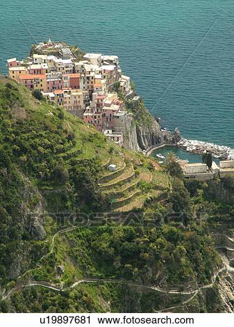 Stock Image -  Cinque Terre, Manarola, Liguria, Italy, Riviera di Levante, Ligurian Riviera, Europe, Scenic view of Manarola, a Cinque Terre village, along the steep rocky coastline of the Ligurian Sea.. Fotosearch
