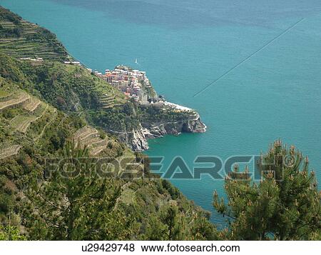 Cinque Terre, Manarola, Liguria, Italy, Riviera di Levante, Ligurian Riviera, Europe, Scenic view of Manarola, a Cinque Terre village, along the steep rocky coastline of the Ligurian Sea. View Large Photo Image Stock Photo - Cinque Terre, Manarola, Liguria, Italy, Riviera di Levante, Ligurian Riviera, Europe, Scenic view of Manarola, a Cinque Terre village, along the steep rocky coastline of the Ligurian Sea.. Fotosearch