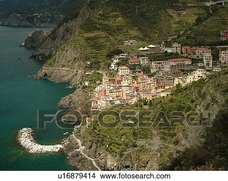 Cinque Terre, Riomaggiore, Liguria, Italy, Riviera di Levante, Ligurian Riviera, Europe, Scenic view of Riomaggiore, a Cinque Terre village, along the steep rocky coastline of the Ligurian Sea. View Large Photo Image Picture - Cinque Terre, Riomaggiore, Liguria, Italy, Riviera di Levante, Ligurian Riviera, Europe, Scenic view of Riomaggiore, a Cinque Terre village, along the steep rocky coastline of the Ligurian Sea.. Fotosearch
