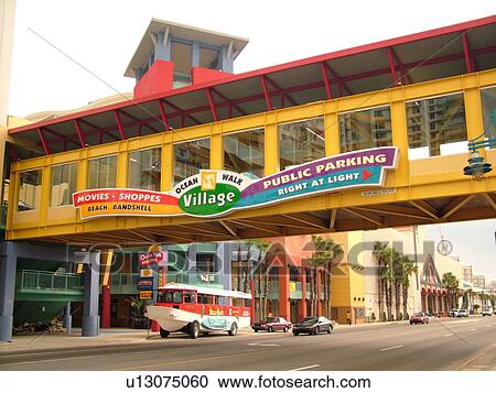 Stock Image -  Daytona Beach, FL, Florida, Ocean Walk Village, pedestrian bridge crosses over the main street. Fotosearch