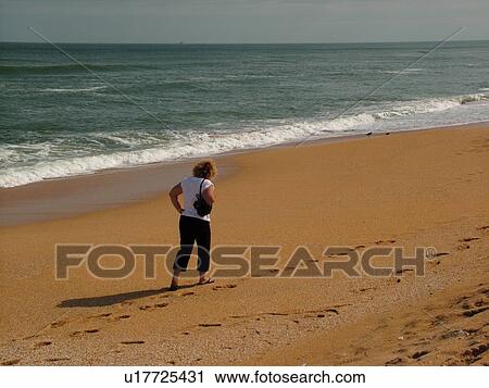 FL, Florida, Atlantic Ocean, Flagler Beach, woman walking on the beach View Large Photo Image Stock Image - FL, Florida, Atlantic Ocean, Flagler Beach, woman walking on the beach. Fotosearch