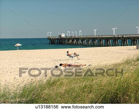 Stock Photograph -  Hillsboro Beach, FL, Florida, ocean, beach, sunbathing, pier. Fotosearch