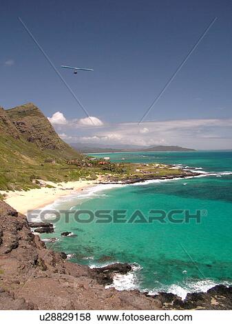 Stock Photo -  Honolulu, Oahu, HI, Hawaii, Windward O'ahu, Makapuu Beach Park, Kalanianaole Highway, scenic coastline, hang gliding. Fotosearch