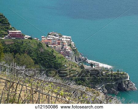 Italy, Cinque Terre, Manarola, Liguria, Riviera di Levante, Ligurian Riviera, Europe, Scenic view of Manarola, a Cinque Terre village, along the steep rocky coastline of the Ligurian Sea. View Large Photo Image Stock Photograph - Italy, Cinque Terre, Manarola, Liguria, Riviera di Levante, Ligurian Riviera, Europe, Scenic view of Manarola, a Cinque Terre village, along the steep rocky coastline of the Ligurian Sea.. Fotosearch