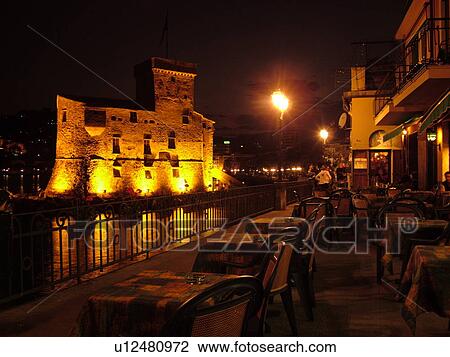 Italy, Rapallo, Riviera di Levante, Liguria, Ligurian Riviera, Europe, The Fortress illuminated at night on the Gulf of Tigullio (Gulfo di Tigullo) in the resort town of Rapallo along the Ligurian Sea on the Ligurian Riviera. View Large Photo Image Stock Image - Italy, Rapallo, Riviera di Levante, Liguria, Ligurian Riviera, Europe, The Fortress illuminated at night on the Gulf of Tigullio (Gulfo di Tigullo) in the resort town of Rapallo along the Ligurian Sea on the Ligurian Riviera.. Fotosearch