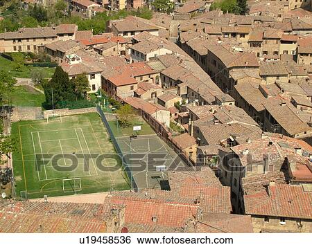 Italy, San Gimignano, Toscana, Tuscany, Europe, Aerial view of the rooftops and soccer field in the medieval town of San Gimignano from Torre Grossa. View Large Photo Image Stock Photograph - Italy, San Gimignano, Toscana, Tuscany, Europe, Aerial view of the rooftops and soccer field in the medieval town of San Gimignano from Torre Grossa.. Fotosearch