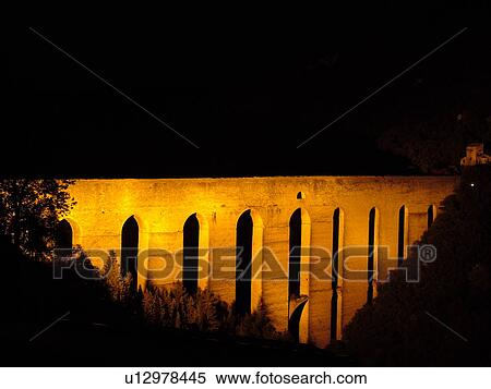 Stock Photography -  Italy, Spoleto, Umbria, Europe, Ponte delle Torri (Bridge of the Towers) illuminated at night in the medieval city of Spoleto.. Fotosearch
